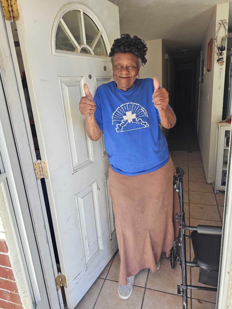 Smiling homeowner at the front door after a completed installation
